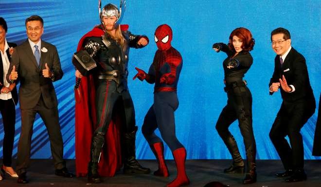 Hong Kong Disneyland’s managing director Samuel Lau (left) and Secretary for Commerce and Economic Development Gregory So (right) strike a pose with Marvel characters Thor, Spider-Man and Black Widow. Unfortunately, superheroes don’t exist in politics. Photo: Reuters