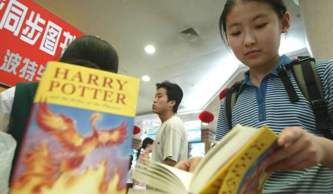 A girl browses a copy of Harry Potter and The Order of the Phoenix at a bookstore in Beijing. Photo: AP