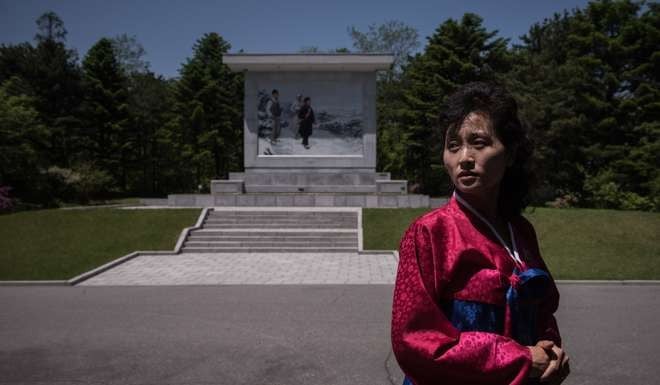 A guide stands before a monument during a tour of Mangyongdae, the birthplace of late founder of North Korea Kim Il-Sung. Photo: AFP