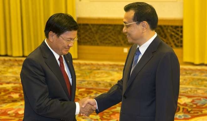 Sisoulith pictured meeting China’s Premier Li Keqiang three years ago at the Great Hall of the People in Beijing. Photo: AFP