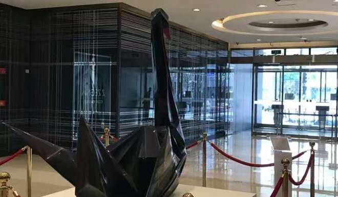 The black swan sculpture looks out from the entrance of the shopping mall – towards the street and the China Securities Regulatory Commission’s headquarters. Photo: SCMP Pictures