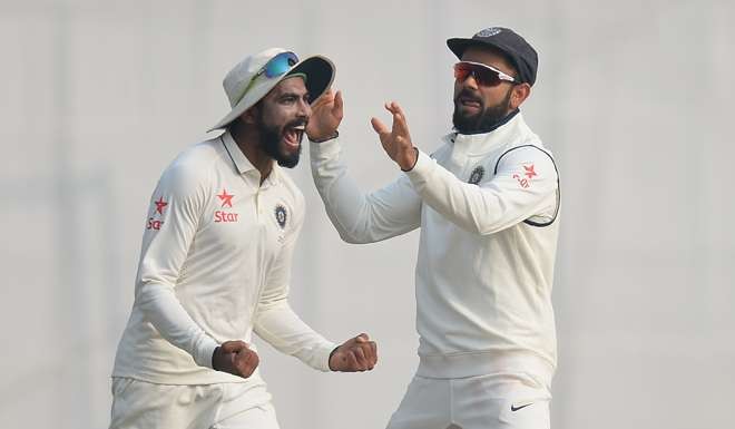 India’s Ravindra Jadeja (left) and captain Virat Kohli celebrate the dismissal of England batsman Jos Buttler. Photo: AFP