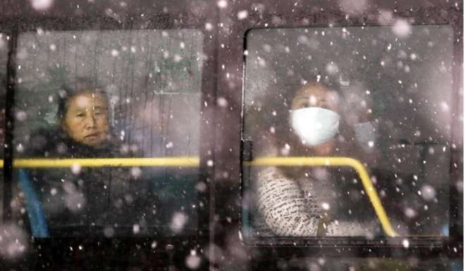 Passengers look through the window on a bus in snow-hit Shenyang, capital of northeast China’s Liaoning province. The most poignant signs of the region’s economic malaise are a falling population and the fact that the northeast’s birth rate is now one-third below the national average. Photo: Xinhua