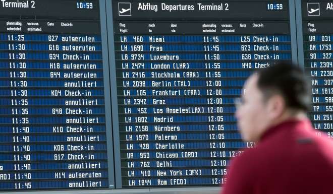 A passenger standing in front of the display board for departures at the airport in Munich, Germany on Tuesday November 29. Pilots at German airline Lufthansa are on strike again. Photo: DPA via AP