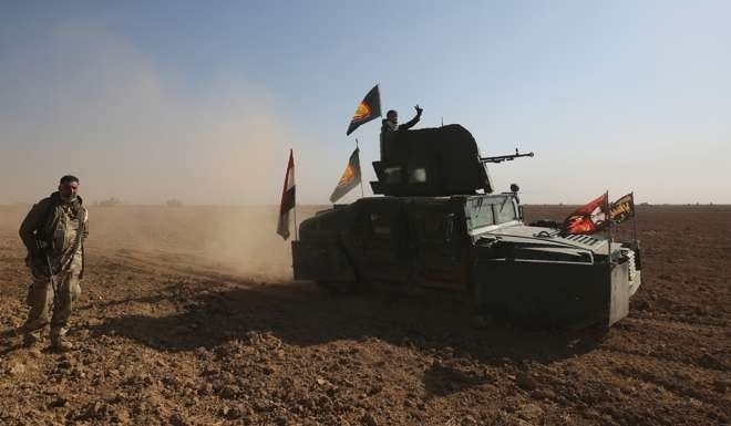 Iraqi troops advance near the village of Tal Faris. Photo: AFP