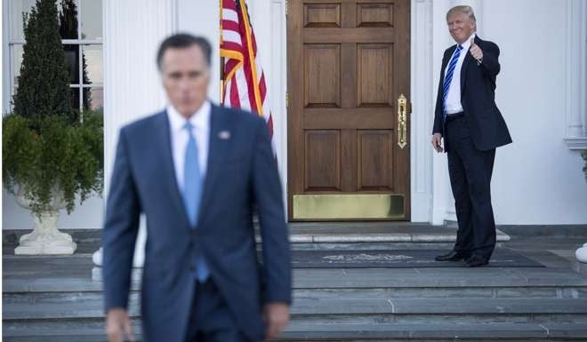 President-elect Donald Trump gives a thumbs up as Mitt Romney leaves after meeting him at the Trump golf club in New Jersey on November 19. Photo: Washington Post