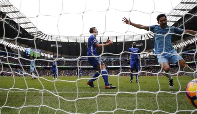 Manchester City's Ilkay Gundogan celebrates after Chelsea's Gary Cahill scored an own goal. Reuters