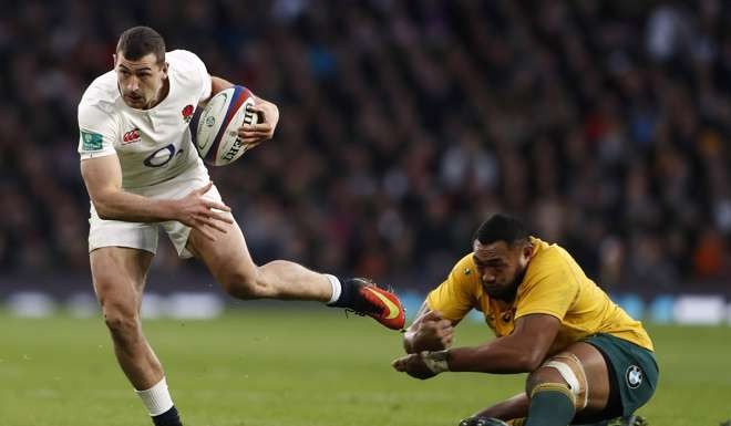 England's Jonny May slips Sekope Kepu’s tackle. Photo: Reuters