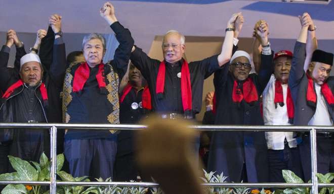 Najib holds hands with other leaders during the protest. Photo: AP