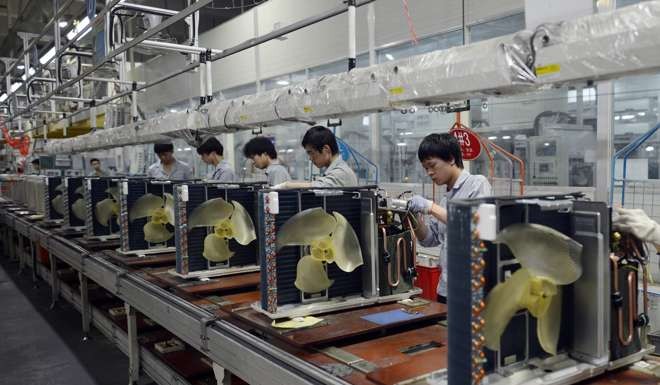 Workers assemble air conditioners at a factory of Gree Electric Appliances in Wuhan. A spike in its share price last week sparked speculation that capital strong Baoneng was building up a stake in the company. Photo: EPA