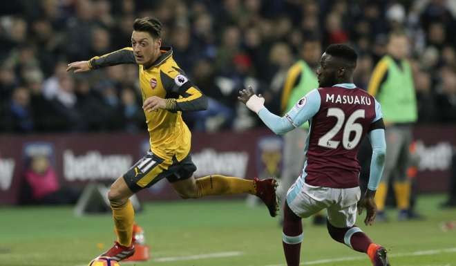 Arsenal's Mesut Ozil beats West Ham's Arthur Masuaku in the Gunners 5-1 win. Photo: AP