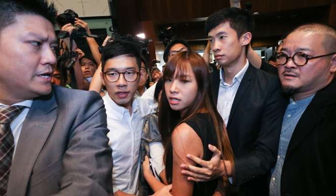 Yau Wai-ching and Sixtus Baggio Leung (second right) are surrounded by pro-democratic lawmakers, including Nathan Law (second left), as they force their way to the chamber at the Legislative Council in Tamar on October 26. Photo: Sam Tsang