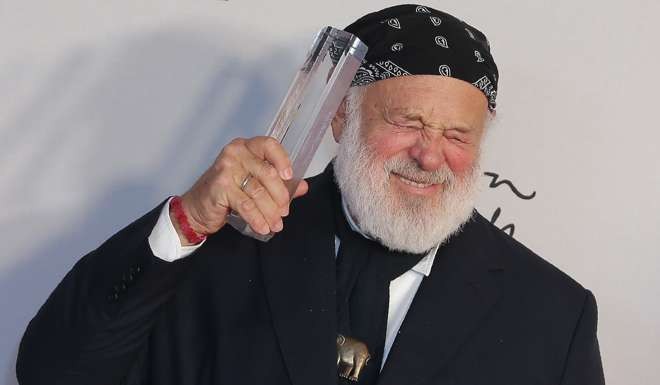 Photographer Bruce Weber poses with his award. Photo: AFP