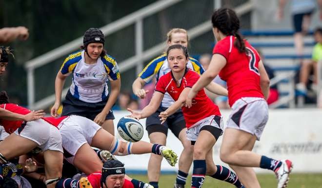 Scrum half Jessica Ho dishes off to a teammate during Hong Kong’s warm-up match against Kazakhstan.