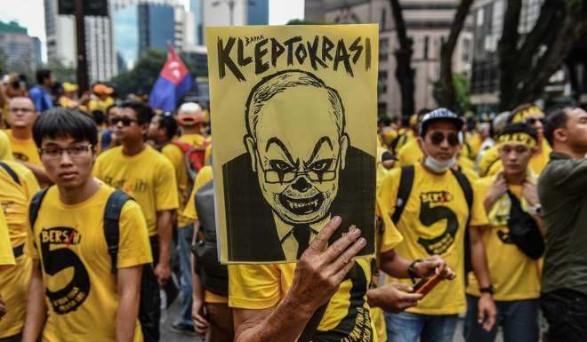 A protester holds a caricature poster depicting Malaysian Prime Minister Najib Razak during a mass rally organised by Bersih 5.0 calling for his resignation in Kuala Lumpur. Photo: AFP
