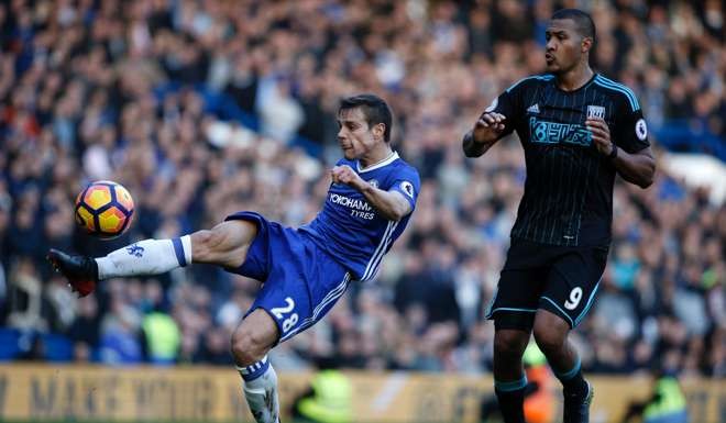 Chelsea defender Cesar Azpilicueta clears the ball under pressure from West Bromwich Albion striker Salomon Rondon. Photo: AFP