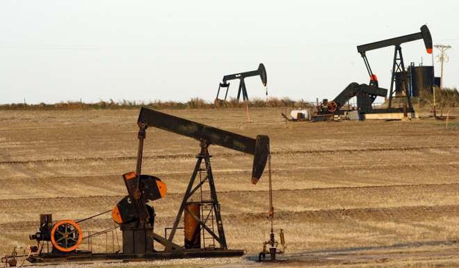 Oil wells pumping oil in a near Ponca City, Oklahoma, USA. Photo: EPA