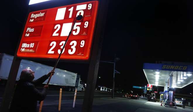 Leon Balagula changes the price for the gasoline at his Sunoco station in the early morning in Fort Lee, N.J. Photo: AP