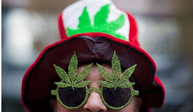 A man wearing a marijuana-themed hat and sunglasses is pictured at the Vancouver Art Gallery during the annual 4/20 day, which promotes the use of marijuana. Photo: Reuters