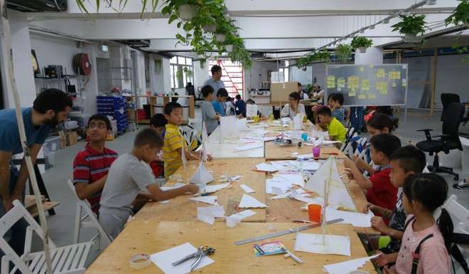 Children make wind trains at Makerbay's headquarters in Yau Tong.