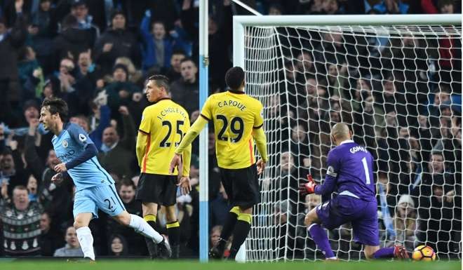 Manchester City's Spanish midfielder David Silva (L) celebrates scoring his team's second. AFP