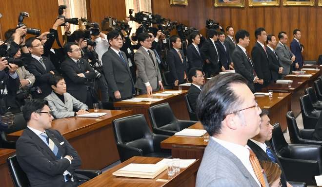 Lawmakers from the ruling Liberal Democratic Party stand up to show support, while members of the LDP's coalition partner Komeito remain seated, for a bill to legalise forms of casino gambling in Japan. Photo: Kyodo