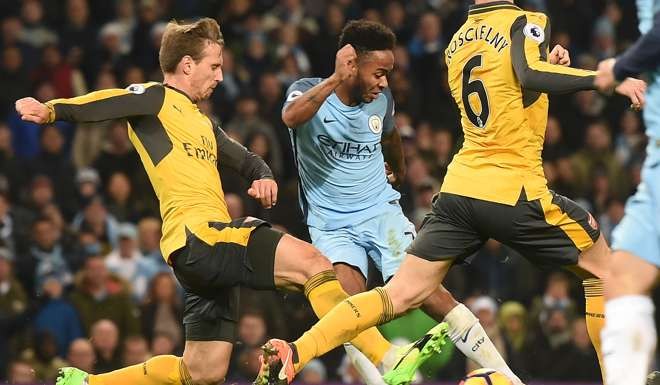 Manchester City’s Raheem Sterling shoots past Arsenal's Nacho Monreal to score the winner. Photo: AFP