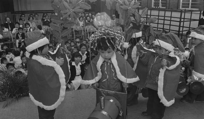 Children in colourful costumes perform a dance at a Christmas party by the Hong Kong Society for the Protection of Children, December 1978.