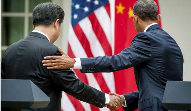 Xi Jinping and Barack Obama shake hands after a joint news conference in the Rose Garden at the White House in Washington in September 2015. Photo: Bloomberg