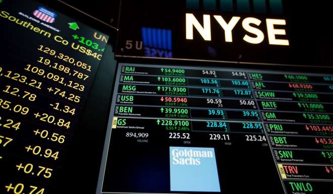 Goldman Sachs signage is displayed on a monitor on the floor of the New York Stock Exchange. Photo: Bloomberg