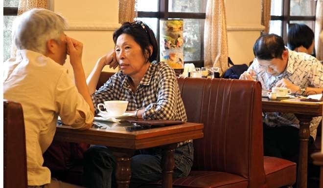 Taiwanese drink coffee at a cafe in Taipei. All four tiger economies must cope with income inequality and rapidly ageing populations. A major transformation is needed. Though difficult, it will be far from painful. Photo: EPA