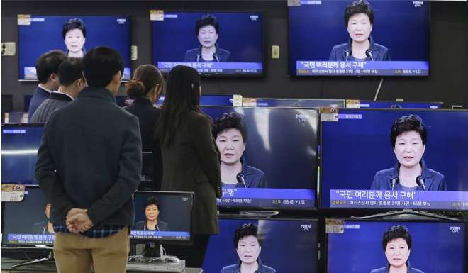People in Seoul watch the live broadcast of South Korean President Park Geun-hye’s address to the nation in an electronics store. The president is mired in an influence-peddling scandal and facing impeachment. Photo: AP