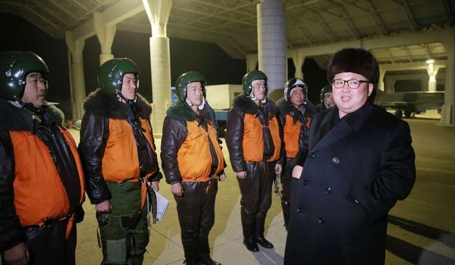 North Korean leader Kim Jong-un meets with pilots at a night assault combat flight drill. Photo: AFP