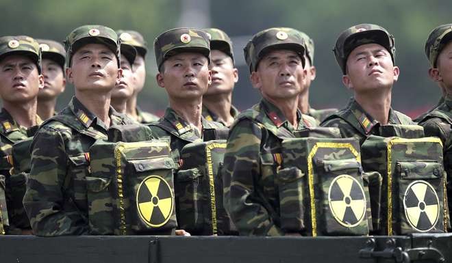 North Korean soldiers carry packs marked with the nuclear symbol during a ceremony marking the 60th anniversary of the Korean War armistice in Pyongyang. File photo: AP
