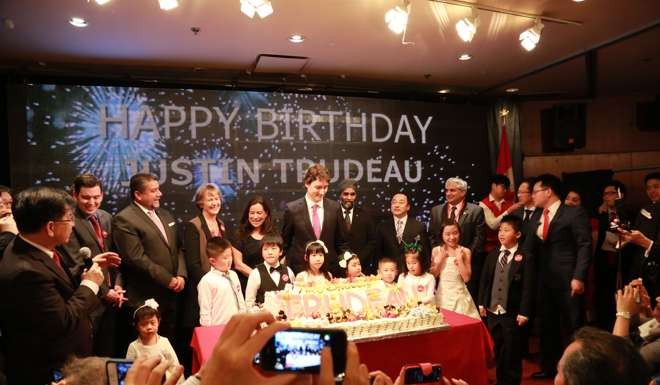 Justin Trudeau (centre) is presented with a birthday cake at Vancouver's Floata Chinese restaurant on December 17, 2013, just two days after the Liberal party was tipped off that donor Michael Ching was a Chinese graft suspect. The 2,000-person Floata event was hosted by volunteers from the Tru-Youths United group that was based in Ching's office; Ching's daughter Linda can be seen, obscured, third from right. Photo: CNTVNA