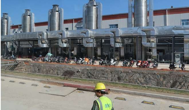 A worker stands outside a CATL factory in Ningde. The company which hopes to list on Beijing’s over-the-counter stock exchange as part of plans to raise at least another 30 billion yuan by 2020, could become a dominant force globally. Photo: Reuters