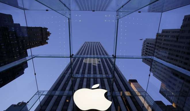 The Apple logo hangs in the glass box entrance to the company's Fifth Avenue store in New York. Photo: AP