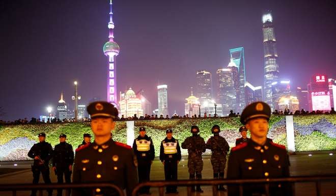 Police officers stand guard at the location where a stampede incident occurred during New Year celebrations two years ago, on the Bund in Shanghai. Photo: Reuters