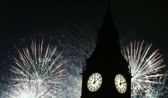 Fireworks explode by the Big Ben clocktower in London. Photo: Reuters