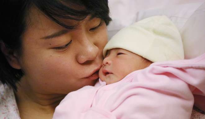 New mum Tsang Sze-wing said she wanted her son to be a polite man with a strong sense of morality. Photo: Felix Wong