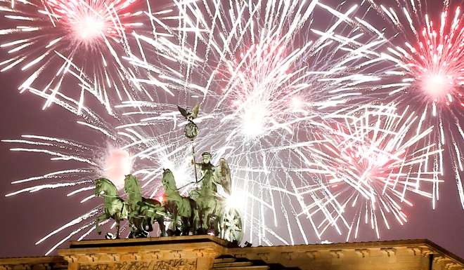 Fireworks explode above the Brandenburg gate. Photo: Reuters