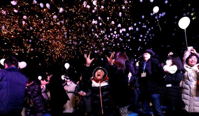 Revellers release balloons as they take part in New Year celebrations in Tokyo. Photo: Reuters