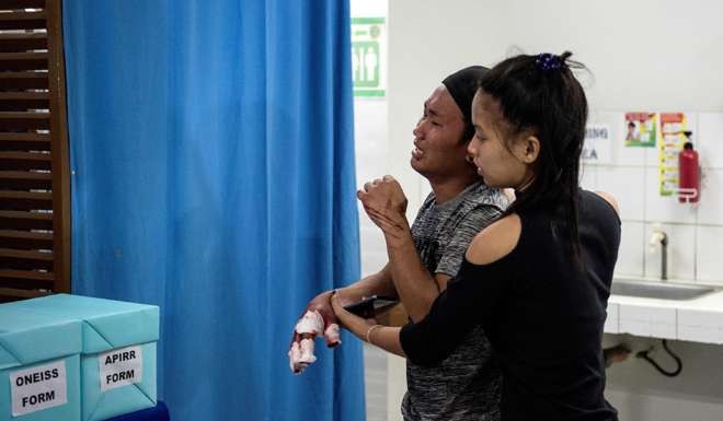 A man injured by a firecracker arrives at a hospital in Manila. Photo: AFP