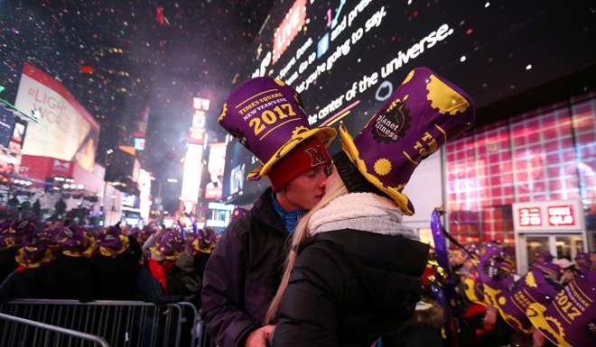 Revellers embrace at the start of 2017 at the New Year's celebration in Times Square in Manhattan. Photo: Reuters