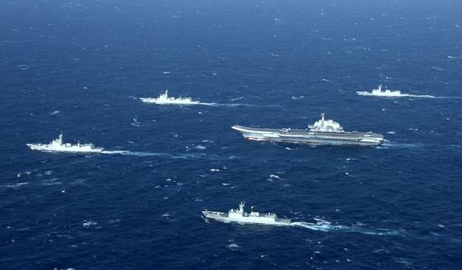 China's Liaoning aircraft carrier (centre) and its escort ships carry out a drill in the South China Sea on Monday. Photo: CNS