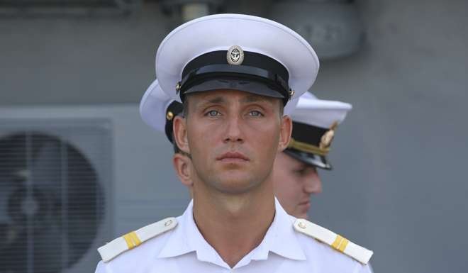 Russian crewmen stand at attention on board the Admiral Tributs. Photo: AP