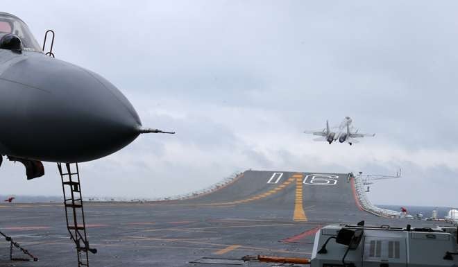 A J-15 jet fighter takes off from the Liaoning aircraft carrier during Monday’s drill in the South China Sea. Photo: CNS