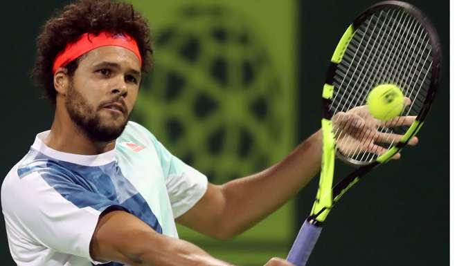 France's Jo-Wilfried Tsonga returns the ball to Andrey Kuznetsov of Russia. Photo: AFP