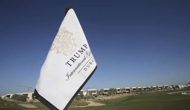 A flag flies on a green at the Trump International Golf Club, in Dubai, United Arab Emirates, where the fairways are lined with villas. The 18-hole golf course exemplifies the questions and risks surrounding his international business interests. Photo: AP
