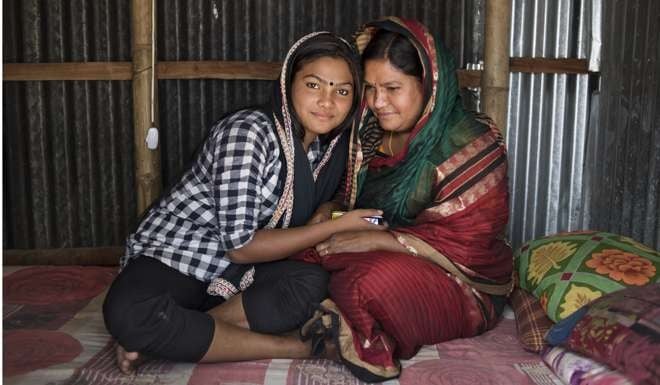Seventeen-year-old Labonno (left) and her mother, Lipi, in her room in C&B Ghat. After her husband died of tuberculosis, Lipi accepted a madam’s offer of work at the brothel, where she became pregnant with Labonno, who was born in the same room in which she was conceived. Labonno now works alongside her mother.